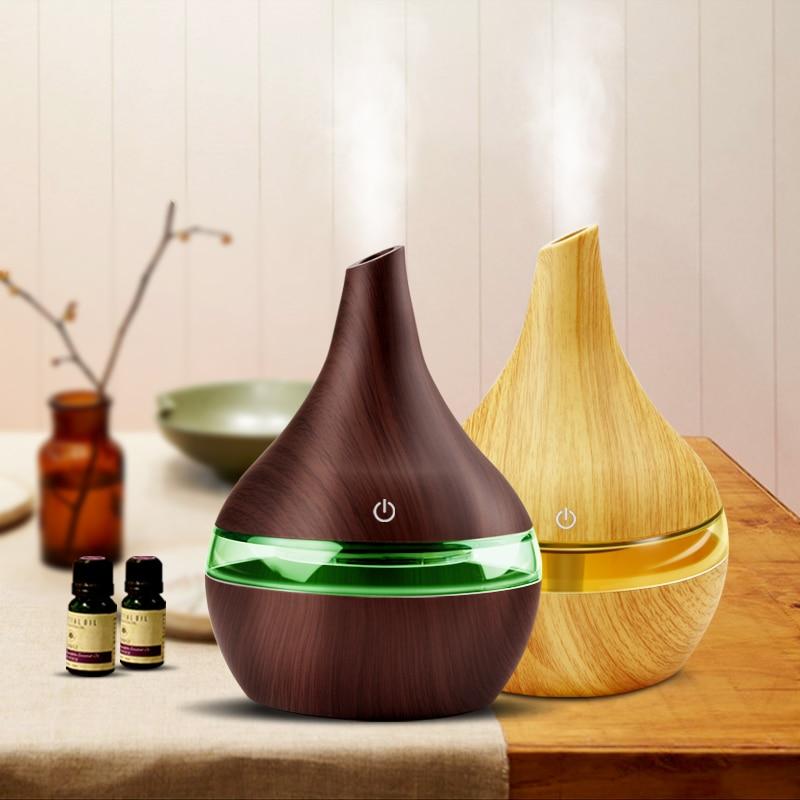 USB aromatherapy humidifier in wood grain design, emitting mist and enhancing air quality on a wooden table.